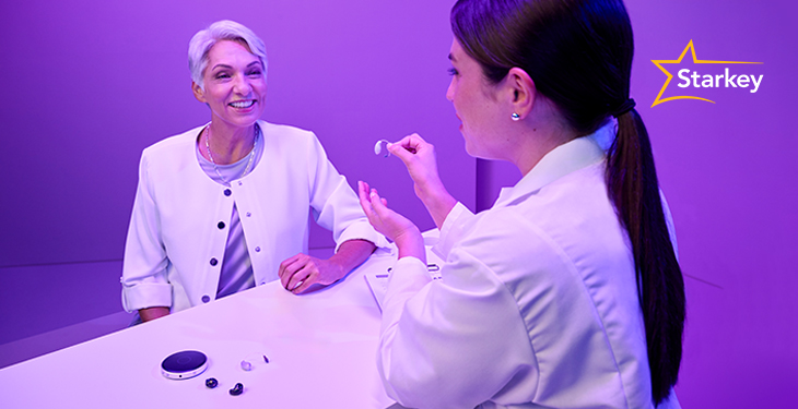 Image of a hearing care professional showing a patient the Starkey Table Microphone